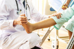 Foot and Ankle Specialist examining patient's feet