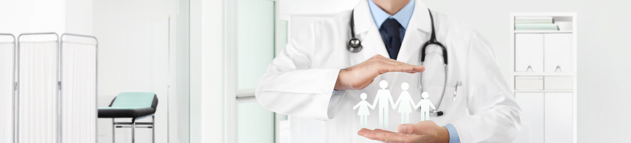 family practice doctor's hand with an icon depicting a family in between