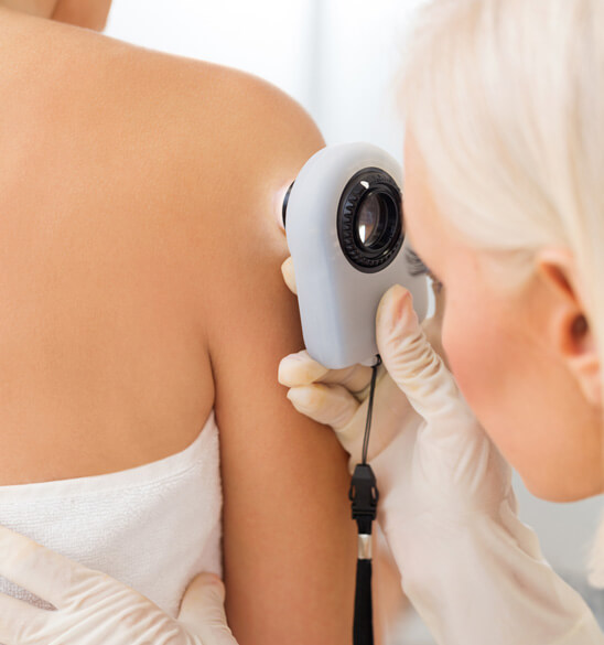 doctor examining patient's skin