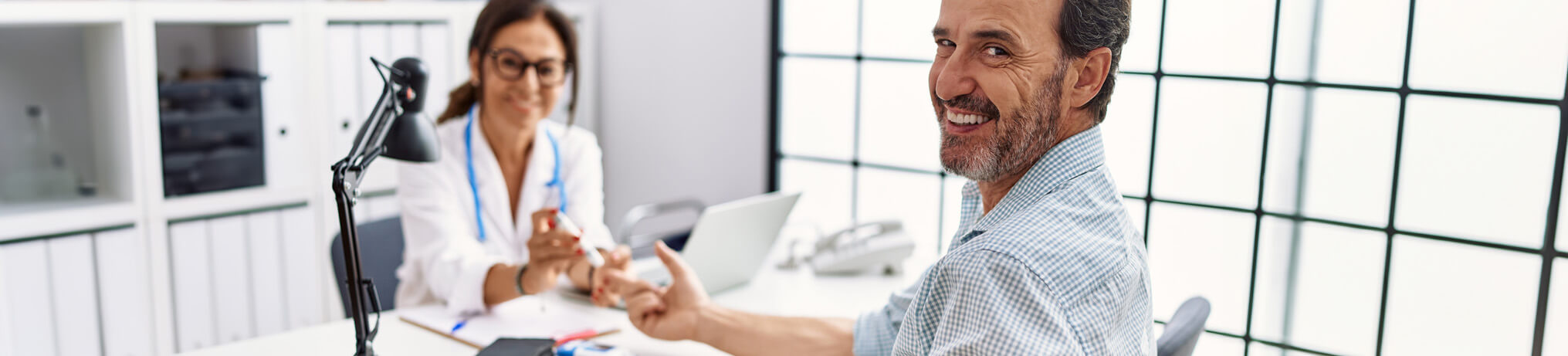 internal medicine doctor testing patient's glucose level