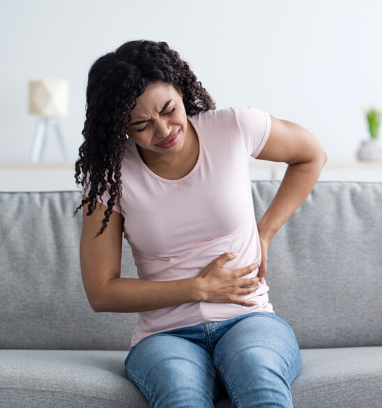 young woman has stomach pain in need of the best nephrologist near her