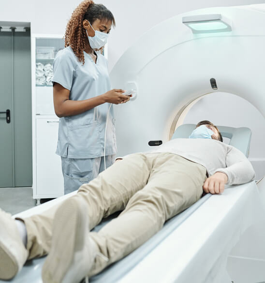 doctor next to patient in an MRI machine