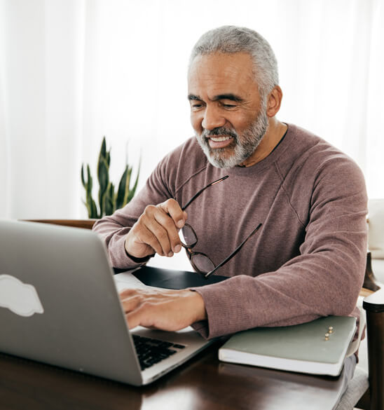 man looking at his laptop