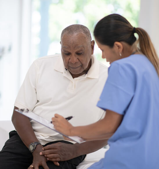 top urologist in NJ helping a patient fill out a form