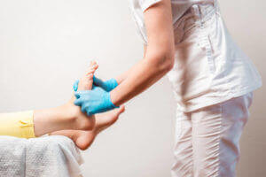 Podiatrist examing patient's feet