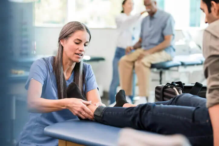 foot doctor examining patient's feet