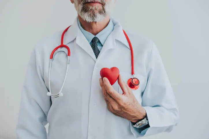 a cardiologist holding a fake heart