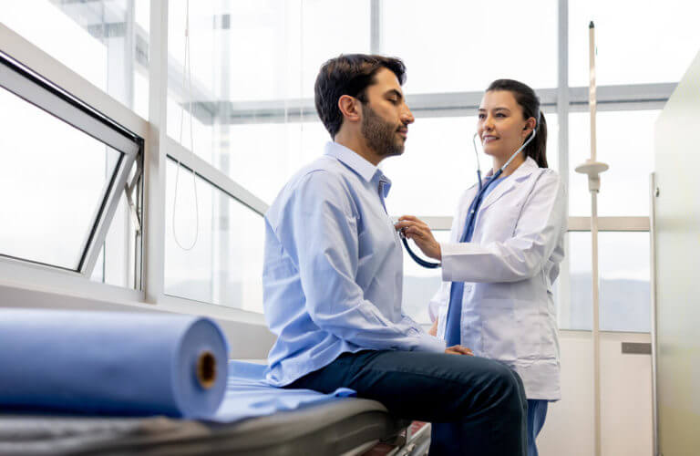 interventional cardiologist examining a patient at her office