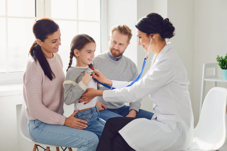 Happy family on a visit to the doctor at preventive care