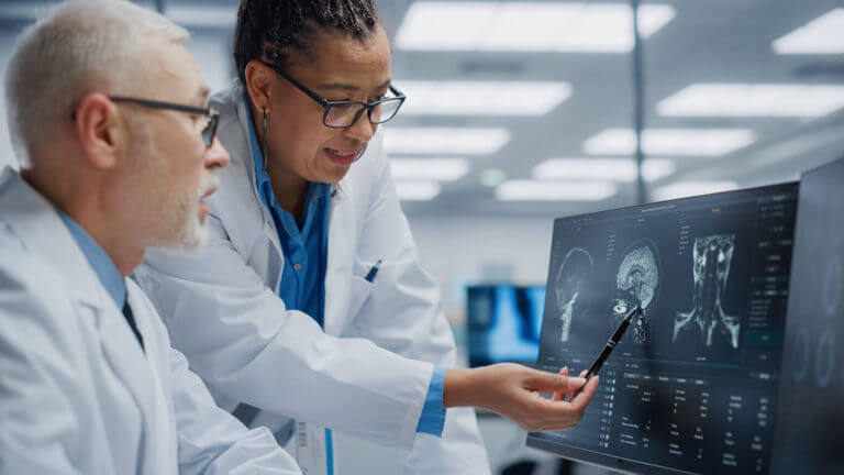 Neurologist and Neurosurgeon analysing MRI scan