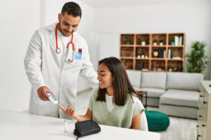 Young woman getting treatment from a doctor that specializes in diabetes.