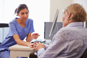 A senior patient is having a consultation with their primary care doctor during a preventive screening visit in the office.