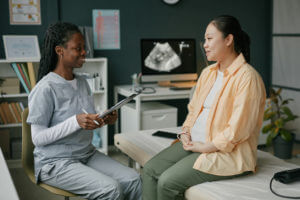 A Pregnant Woman Talking with an OBGYN Doctor