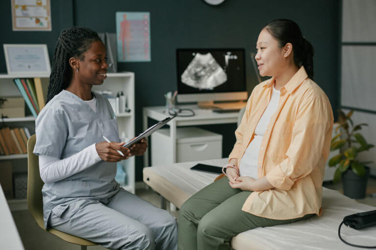 A Pregnant Woman Talking with an OBGYN Doctor